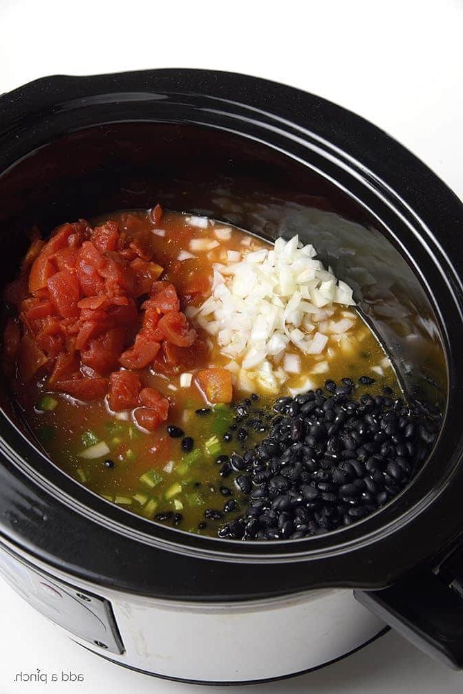 Slow cooker filled with ingredients for black bean soup // puvez.com