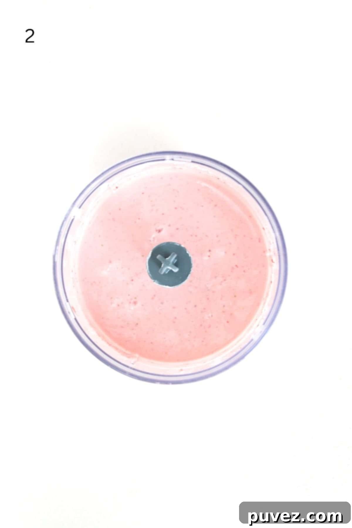 Smooth, creamy strawberry fruit dip blended in a food processor, ready for serving.