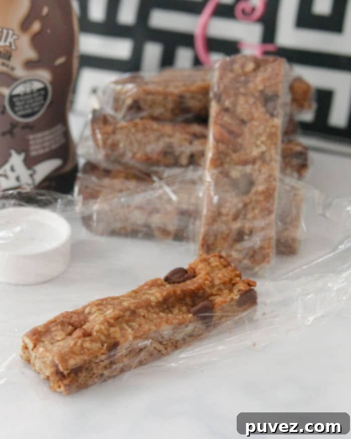 Hand holding a fresh Peanut Butter Chocolate Chip Granola Bar