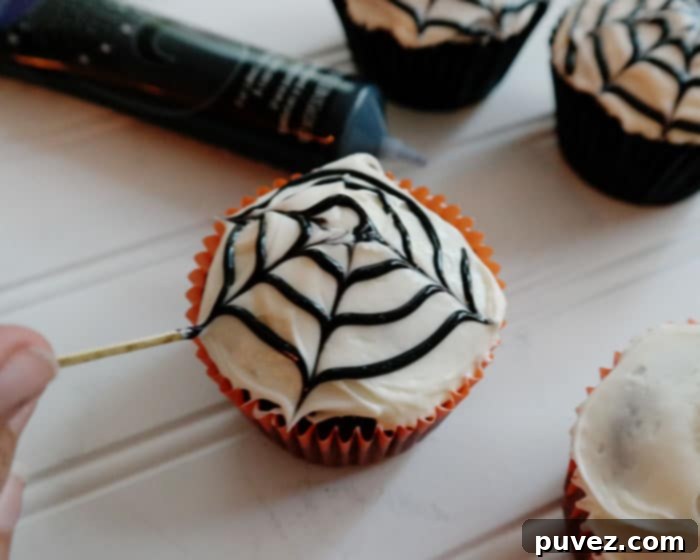 Make Spider Web Cupcakes with a swirl of black icing and a toothpick!