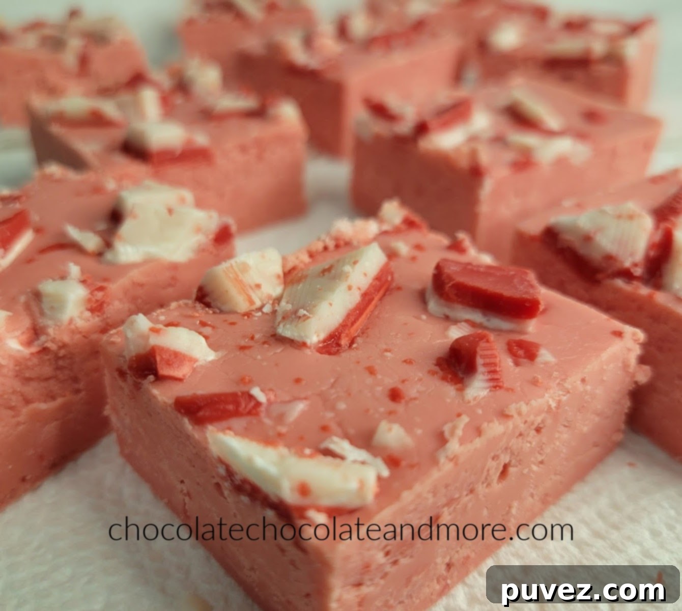 Close-up of freshly made Easy Andes Peppermint Fudge being cut into squares, showing its smooth texture and mint swirl