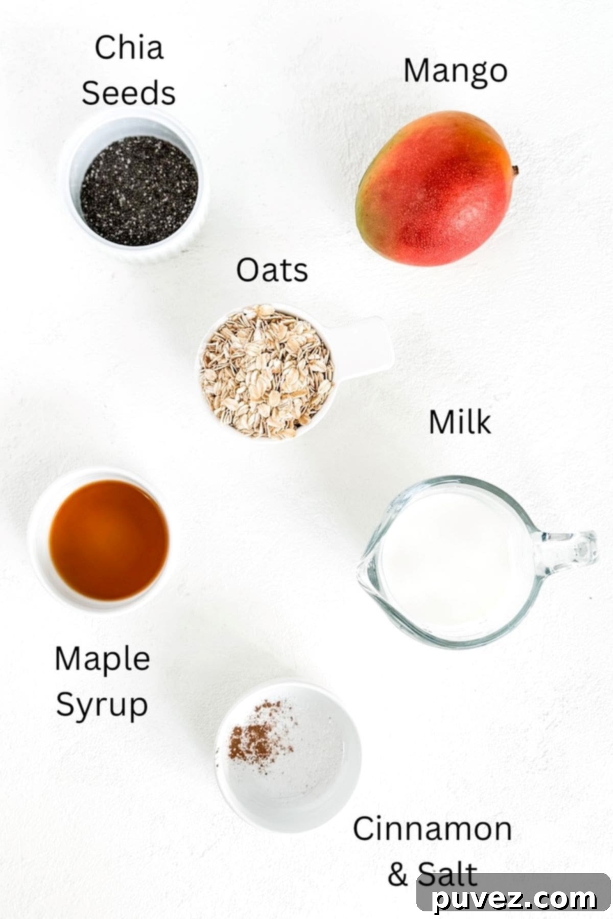 Labeled ingredients for Mango Overnight Oats laid out on a surface.