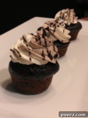 Decadent Mudslide Cupcakes with frosting and chocolate drizzle