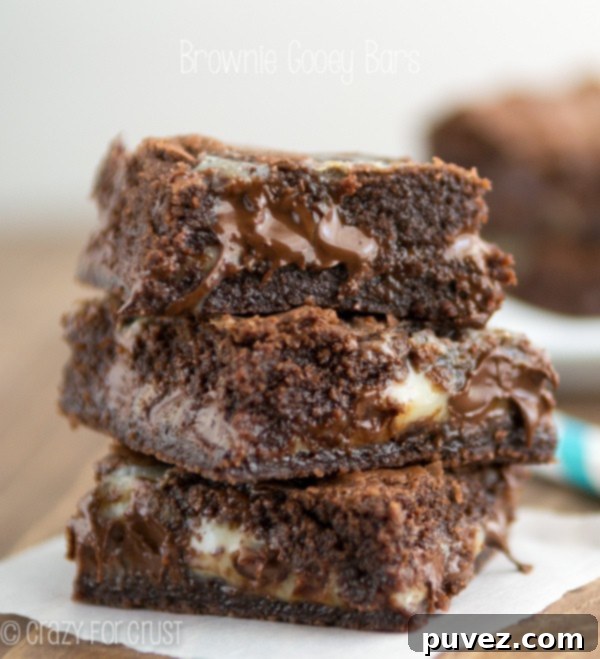 Decadent Brownie Gooey Bars with a thick, chewy layer on top