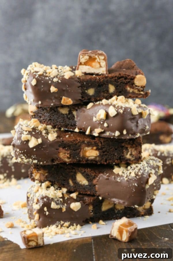 Close-up of freshly baked Snickers cookie bars ready for dipping