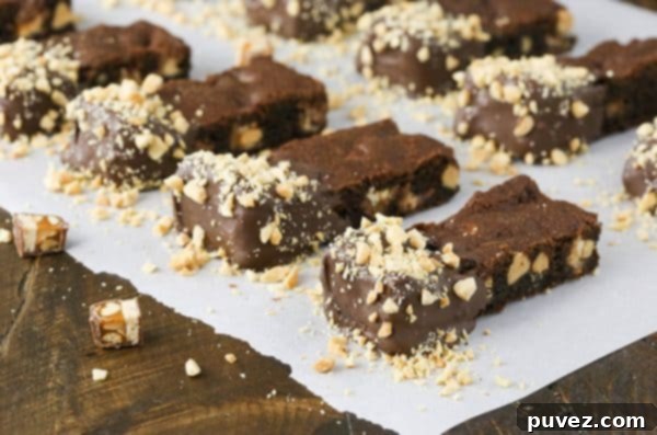 Stacked Chocolate Dipped Snickers Cookie Bars