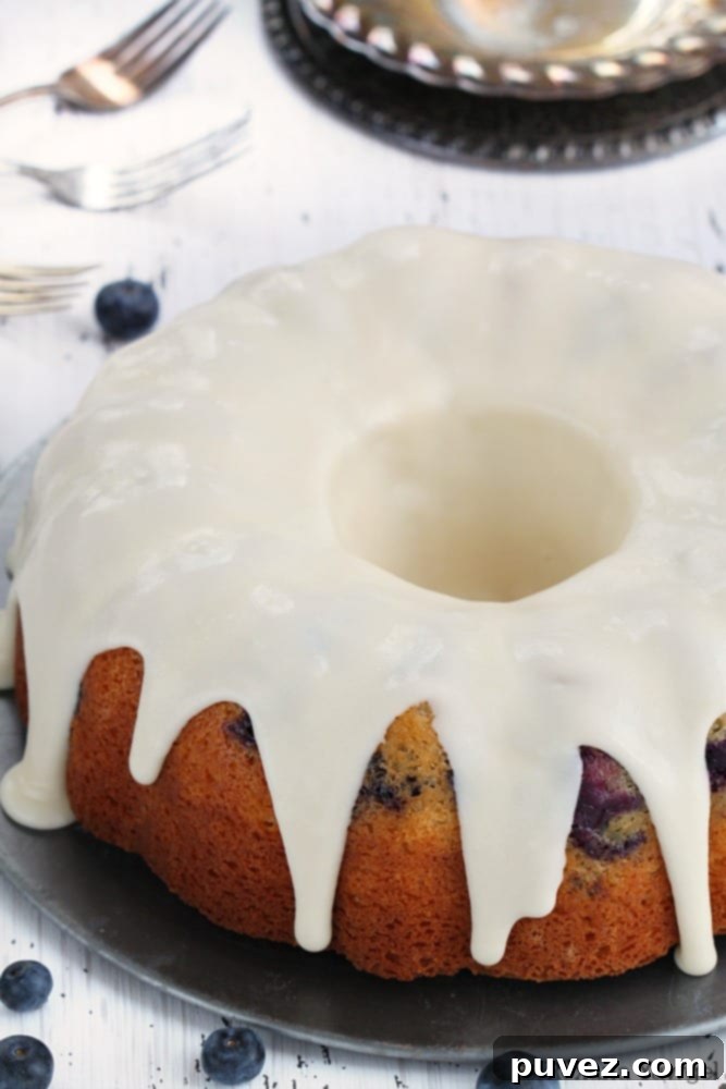 Blueberry bundt cake generously drizzled with sweet lemon icing