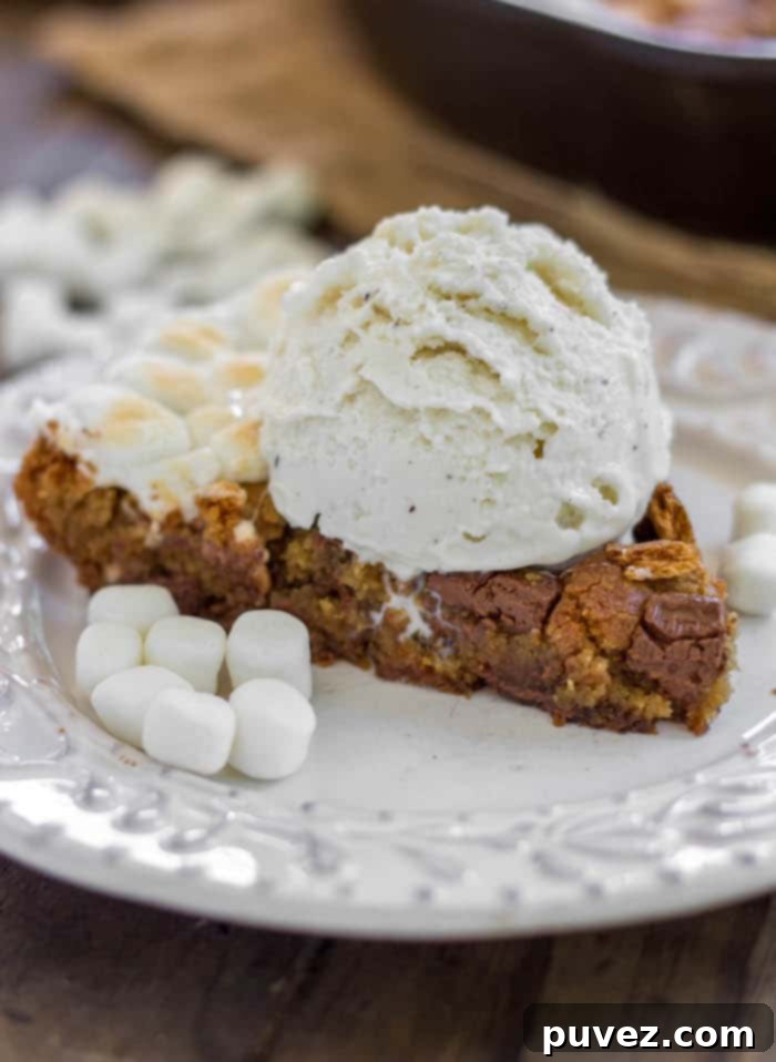 S'mores Skillet Cookie - A brown sugar cookie filled to the brim with chopped Hershey bars, marshmallows and graham crackers.
