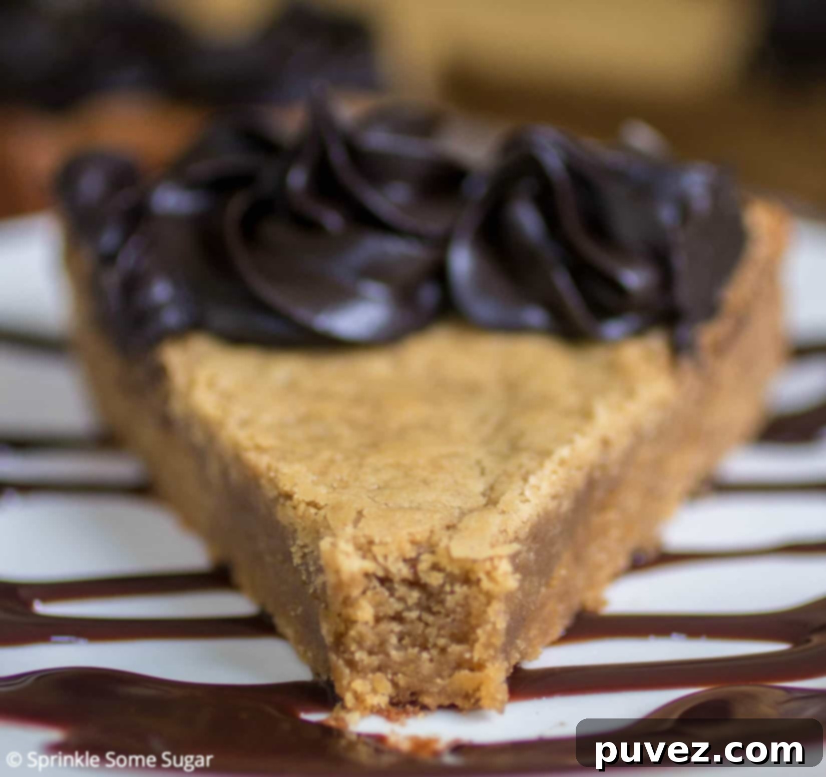 Peanut Butter Cookie Cake with a swirl of dark chocolate frosting and decorative elements.