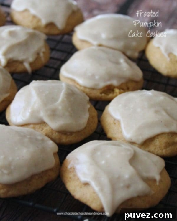 Frosted Pumpkin Cake Cookies with orange frosting.