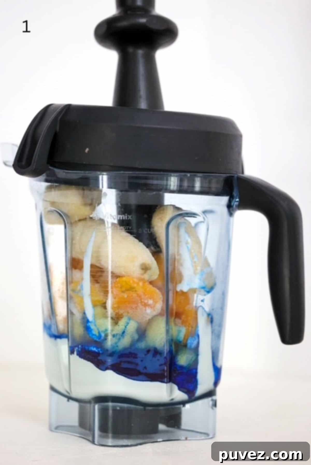 Blue smoothie bowl ingredients in a Vitamix blender.