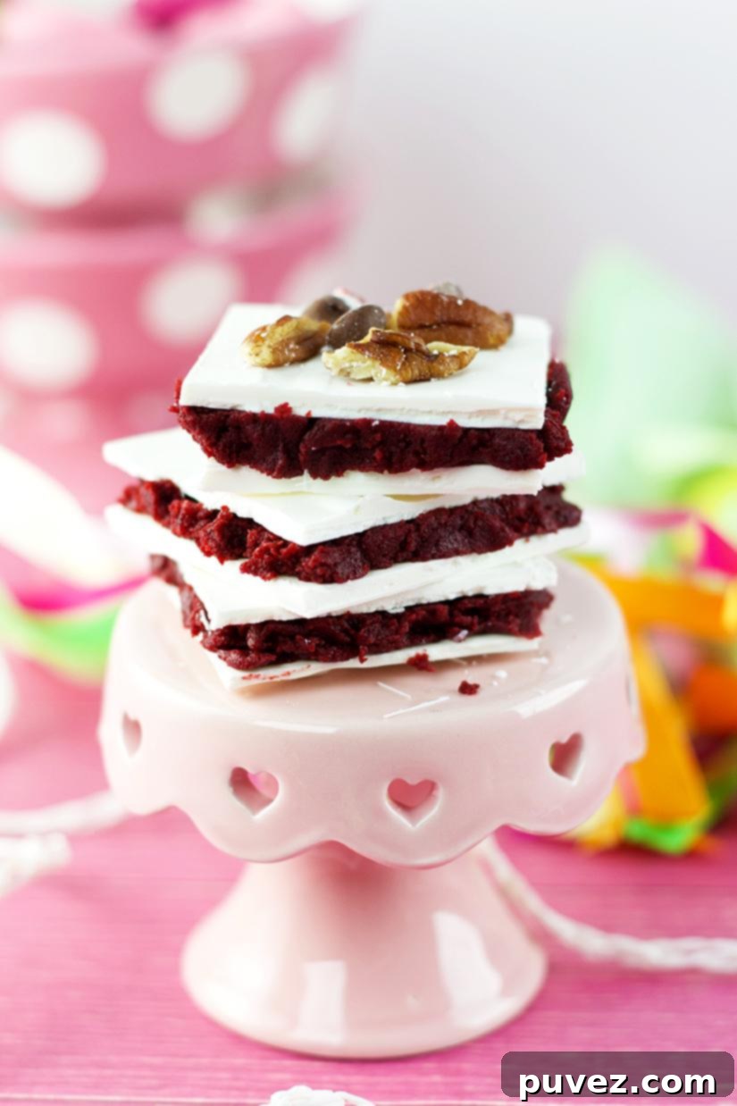 Beautifully layered Red Velvet Truffle Bars, showcasing the vibrant red cake base and smooth white candy coating, ready to be served at any party.