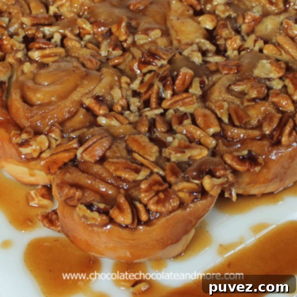 Irresistible Caramel Pecan Sticky Buns, glossy with caramel and topped with pecans