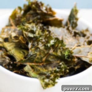 Homemade kale chips in a white bowl.