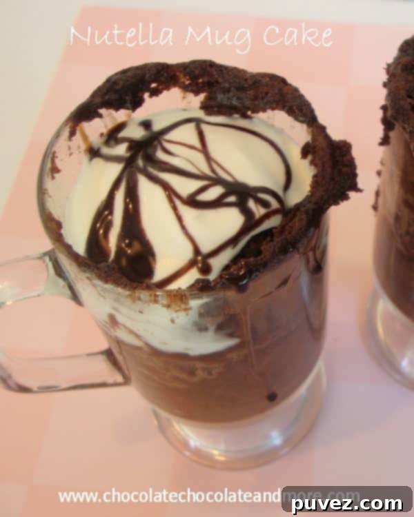 A delectable Nutella Mug Cake with a portion scooped out, showcasing its soft, gooey interior