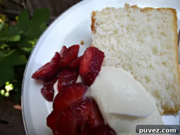 Snow Cake slice with strawberries and cream from BakeThisCake