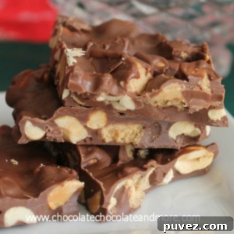 Reese's Peanut Butter Cup Bark on a white surface, with scattered peanut butter cups.