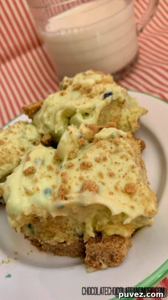 Three perfectly chilled Birthday Cake Pudding Bars on a white plate with a green rim, next to a refreshing glass of milk, showcasing their vibrant sprinkle topping.