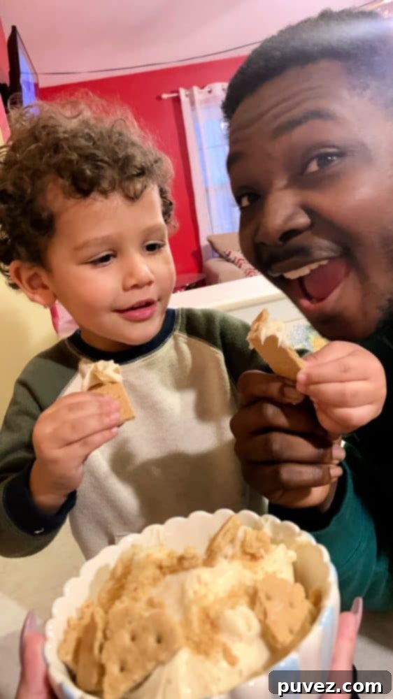 A candid photo of a child (Edward) and an adult (Kal) enjoying the 3-Ingredient Cheesecake Dip, with the child reaching for the dip.