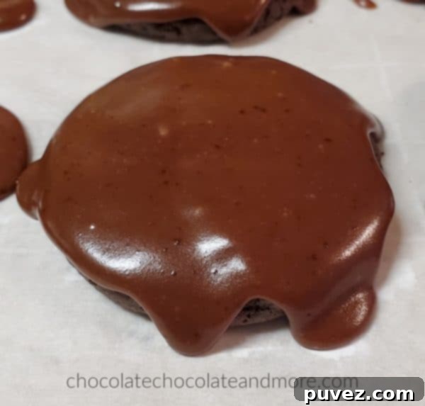 A freshly baked Texas Chocolate Cookie, generously dripping with rich, fudgy chocolate frosting.
