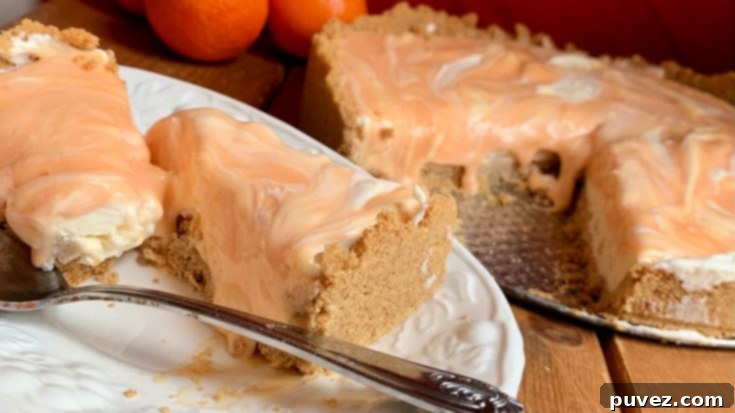 Orange Creamsicle Swirl Cheesecake - A no-bake dessert featuring creamy vanilla and vibrant orange swirled together.