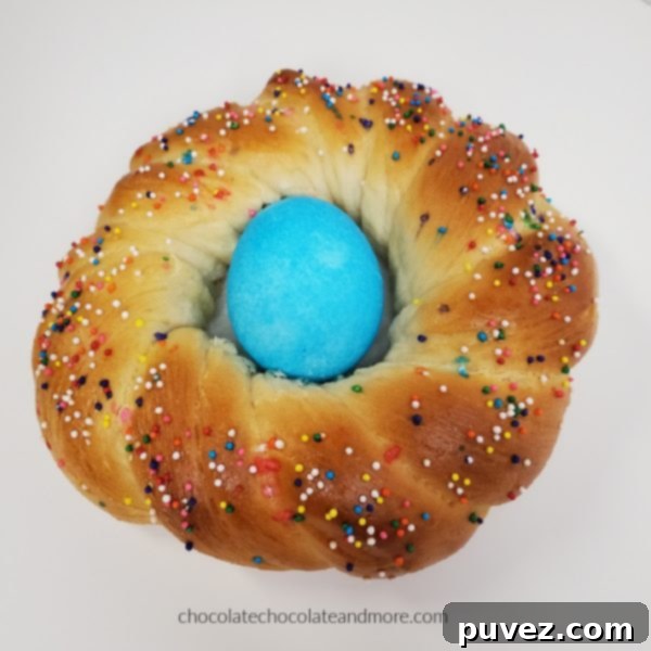 a closeup of a Easter bread braid with a blue egg in the middle