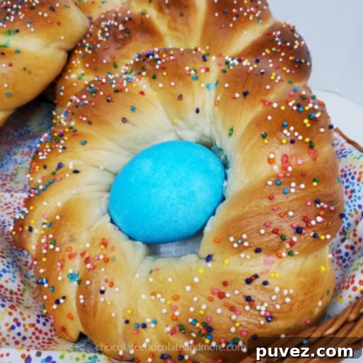 Traditional Italian Easter Bread 7 A twisted Italian Easter Bread covered in colorful sprinkles and a blue Easter egg.
