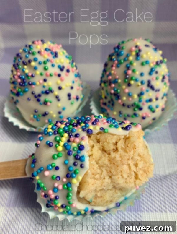 Three Easter egg Cake Pops, one with a bite taken out, resting in mini cupcake holders on a vibrant purple and white plaid background, showcasing their delicious texture.