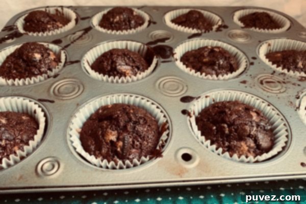 A cupcake tray of unfrosted Oreo Brownie Cups fresh out of the oven.