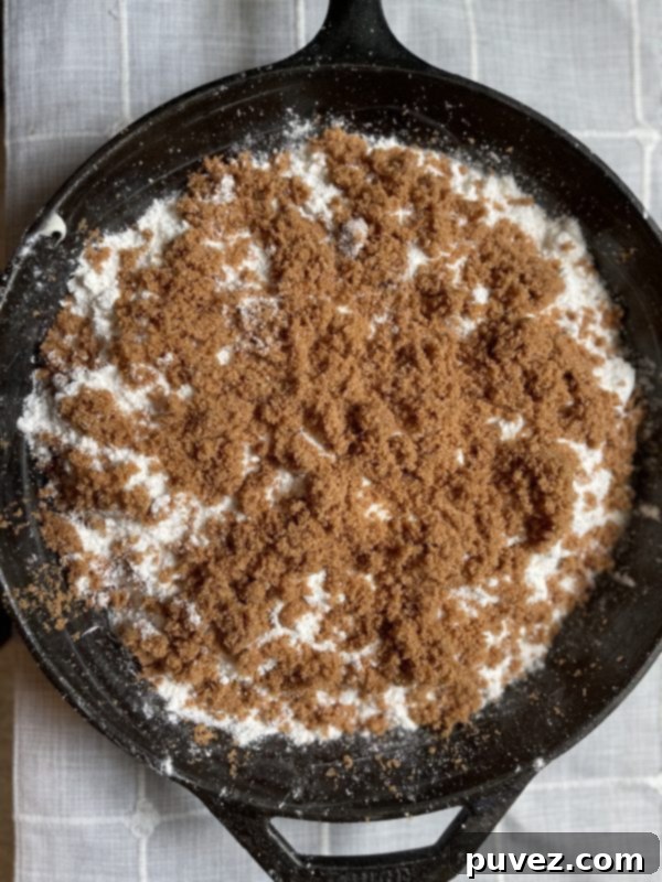 The dry cinnamon swirl crumb cake mix and its included topping evenly distributed over the cream cheese frosting layer.