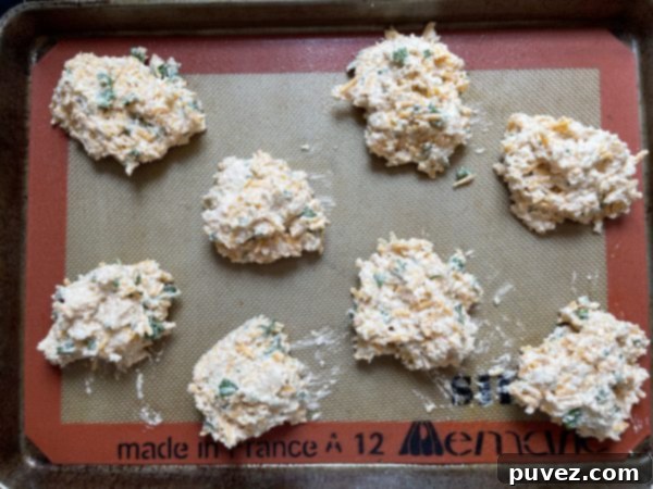 Copycat Red Lobster Cheddar Bay Biscuits remake batter balls on a baking sheet, ready for the oven.