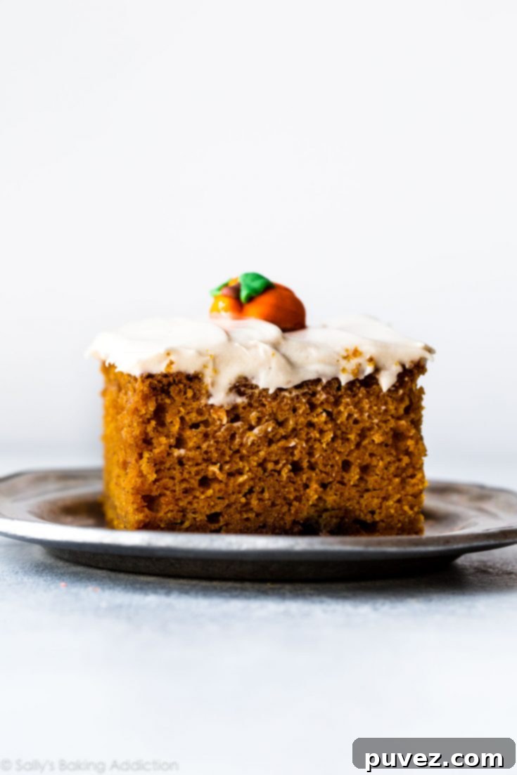 Slice of the Best Pumpkin Cake with cream cheese frosting