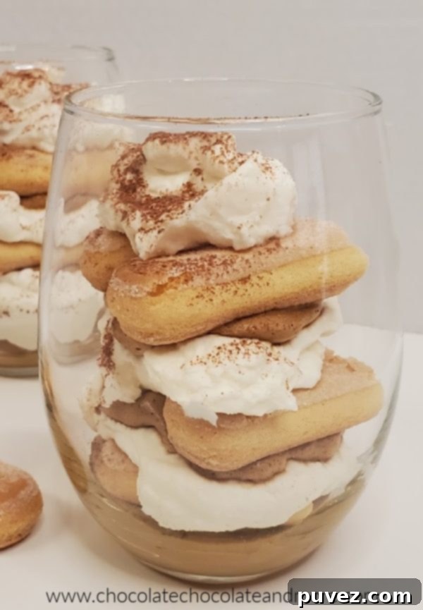 a clear glass filled with whipped coffee and tiramisu