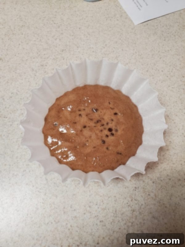 Quick And Easy 1 Minute Mug Cake 5 A chocolate mug cake perfectly unmolded onto a white plate, showcasing its fluffy texture.
