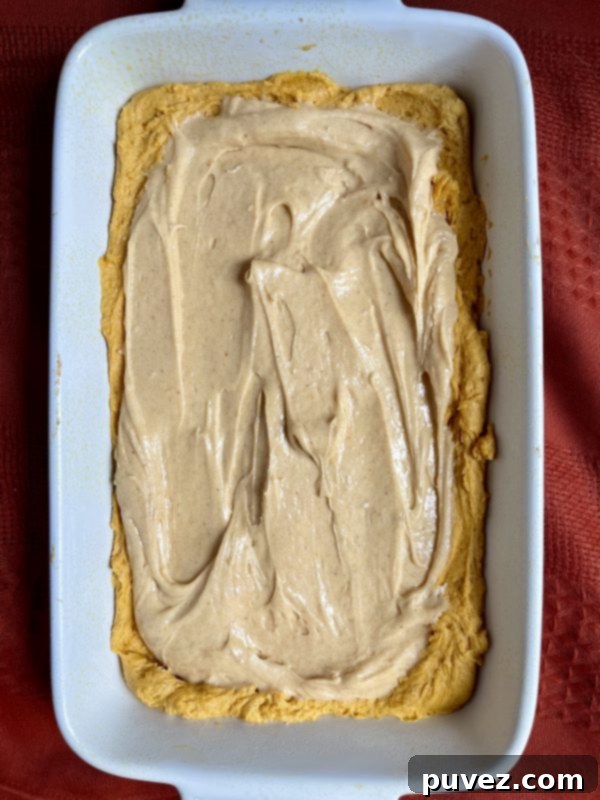 The cake mixture with the cream cheese filling ontop.
