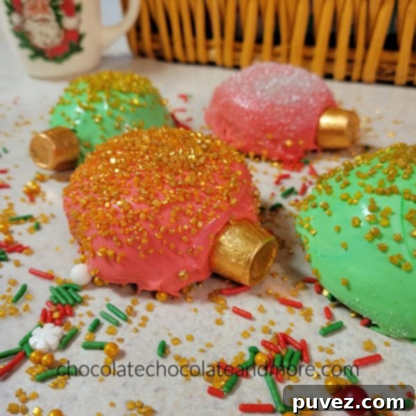 A delightful collection of ornament shaped cupcakes, each adorned with a variety of colorful sprinkles, ready for a festive display.