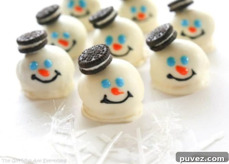 Adorable Melted Snowmen Oreo Balls with pretzel arms and candy details, perfect for a winter treat.