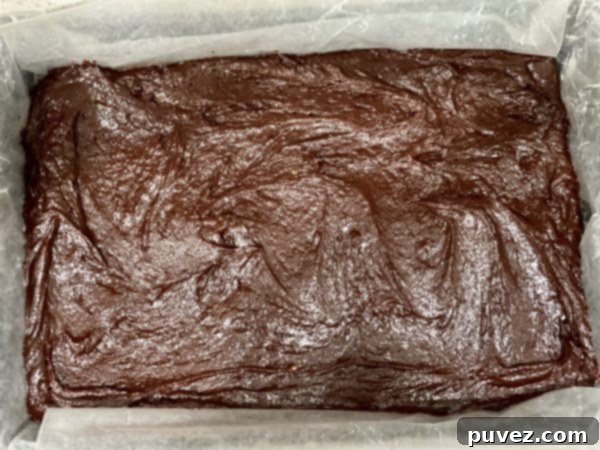 Brownie batter spread into a 9x13 pan