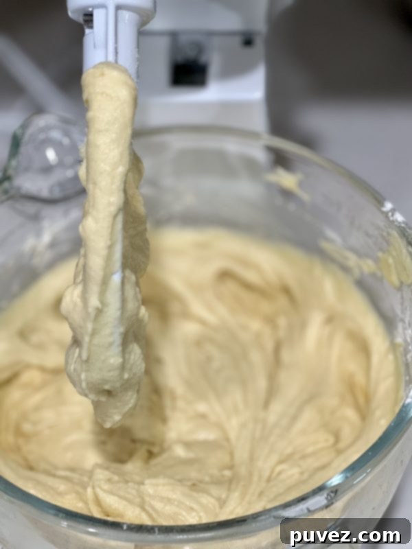 Cake batter after heavy whipping cream and flour have been added, showing a thicker consistency.