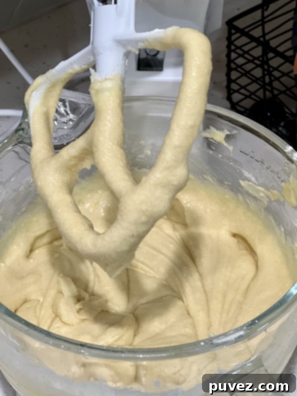Cake batter after vanilla, lemon extract, juice, and zest have been mixed in, adding a vibrant aroma.