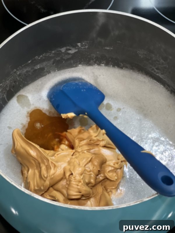 Peanut butter and vanilla extract added to the hot sugar and corn syrup mixture