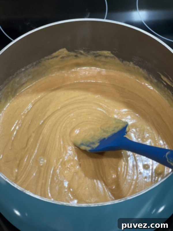 Smooth, well-combined peanut butter and sugar mixture in the saucepan