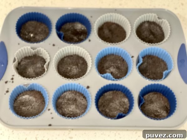Oreo crust pressed into cupcake tray, ready for chocolate filling