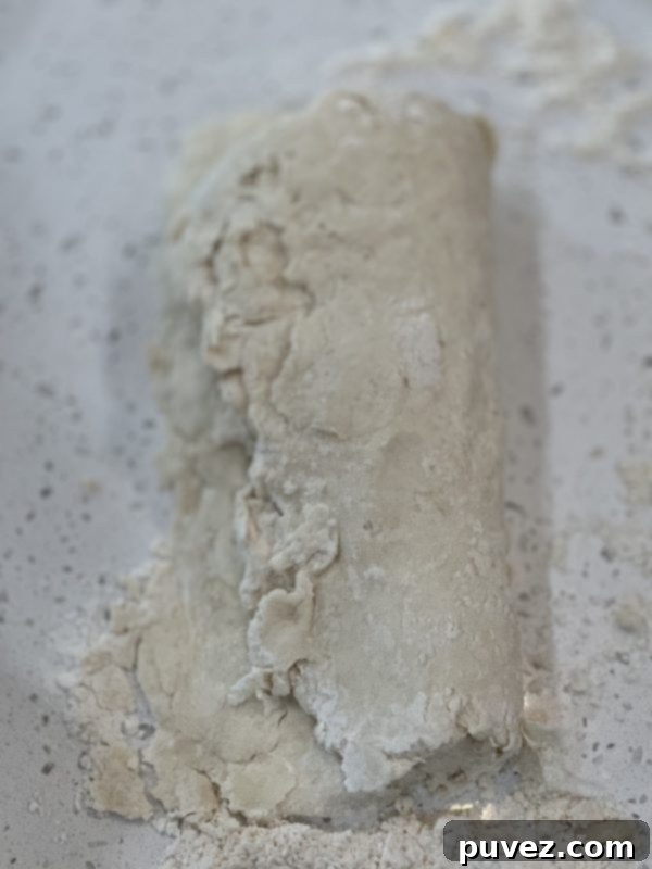 Biscuit dough folded in half again, hot dog style, to further develop layers