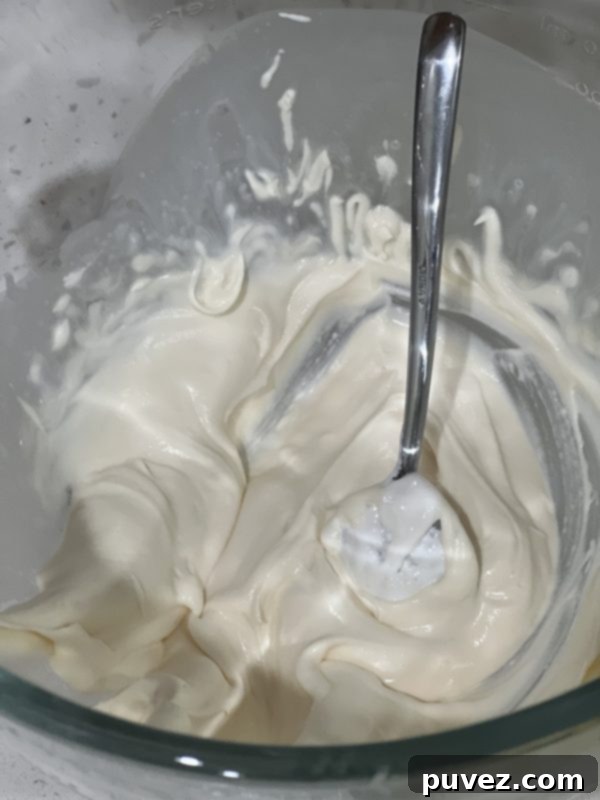 Cream topping in a glass mixing bowl, light and fluffy