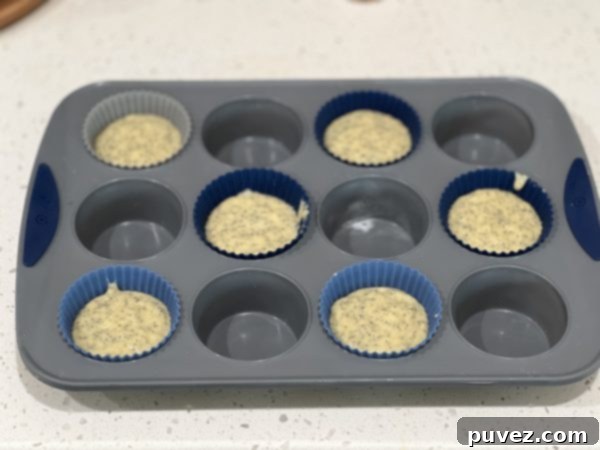 A cupcake pan with batter in alternating cups, demonstrating the expert baking tip for even cooking.