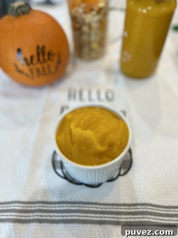 Homemade Pumpkin Puree with a pumpkin, pumpkin seeds and a jar of Homemade Pumpkin Puree sitting be hind it.