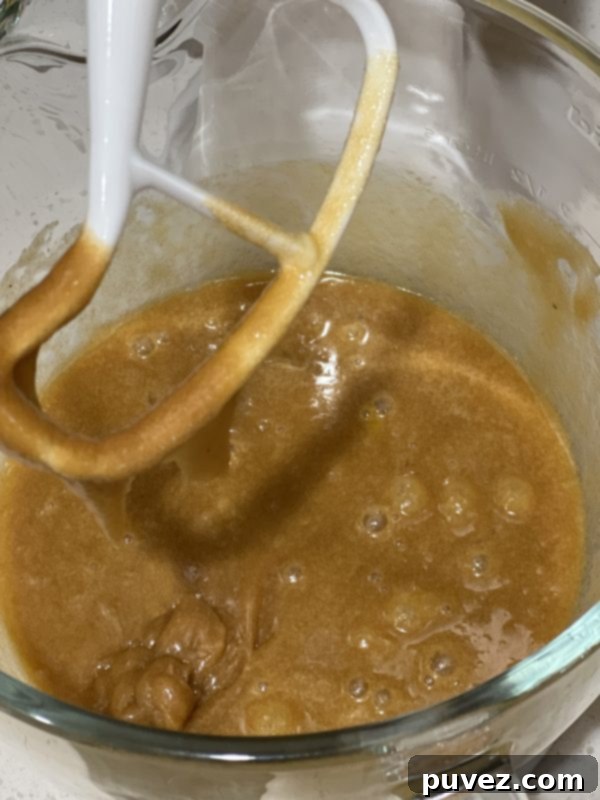 wet ingredients after being mixed in the stand mixer in a glass mixing bowl