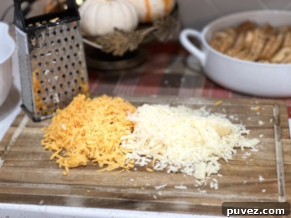 freshly grated cheese on a wood cutting board, ready for the sauce