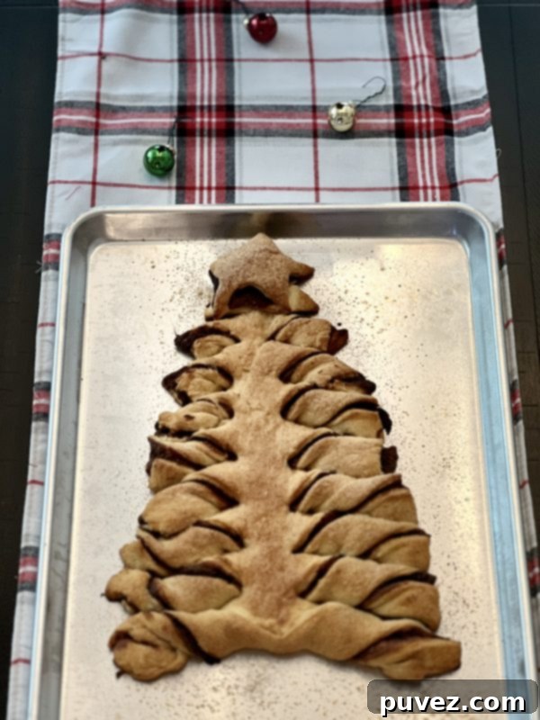 Another beautiful shot of the baked Tear & Share Crescent Christmas Tree on a cookie sheet, ready to be pulled apart and savored, placed on a cozy plaid table runner.